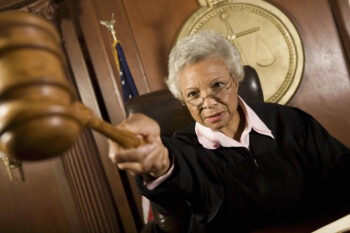 Senior female judge pounding after the judgment in the courtroom