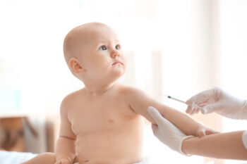 Doctor vaccinating baby in clinic